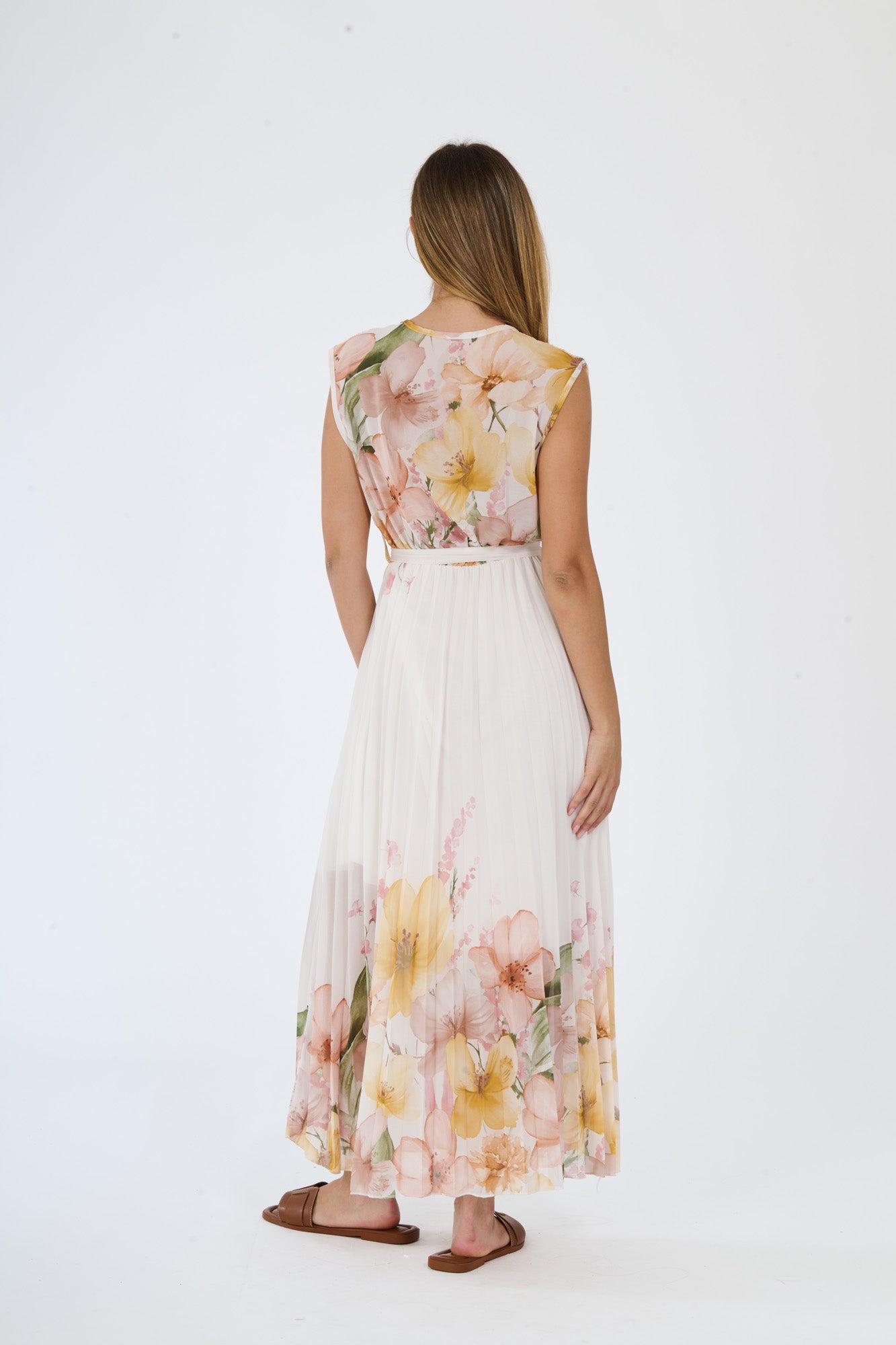 Modella in abito maxi Giallo con motivi floreali, scollatura a V, maniche nude e fascia tie - waist