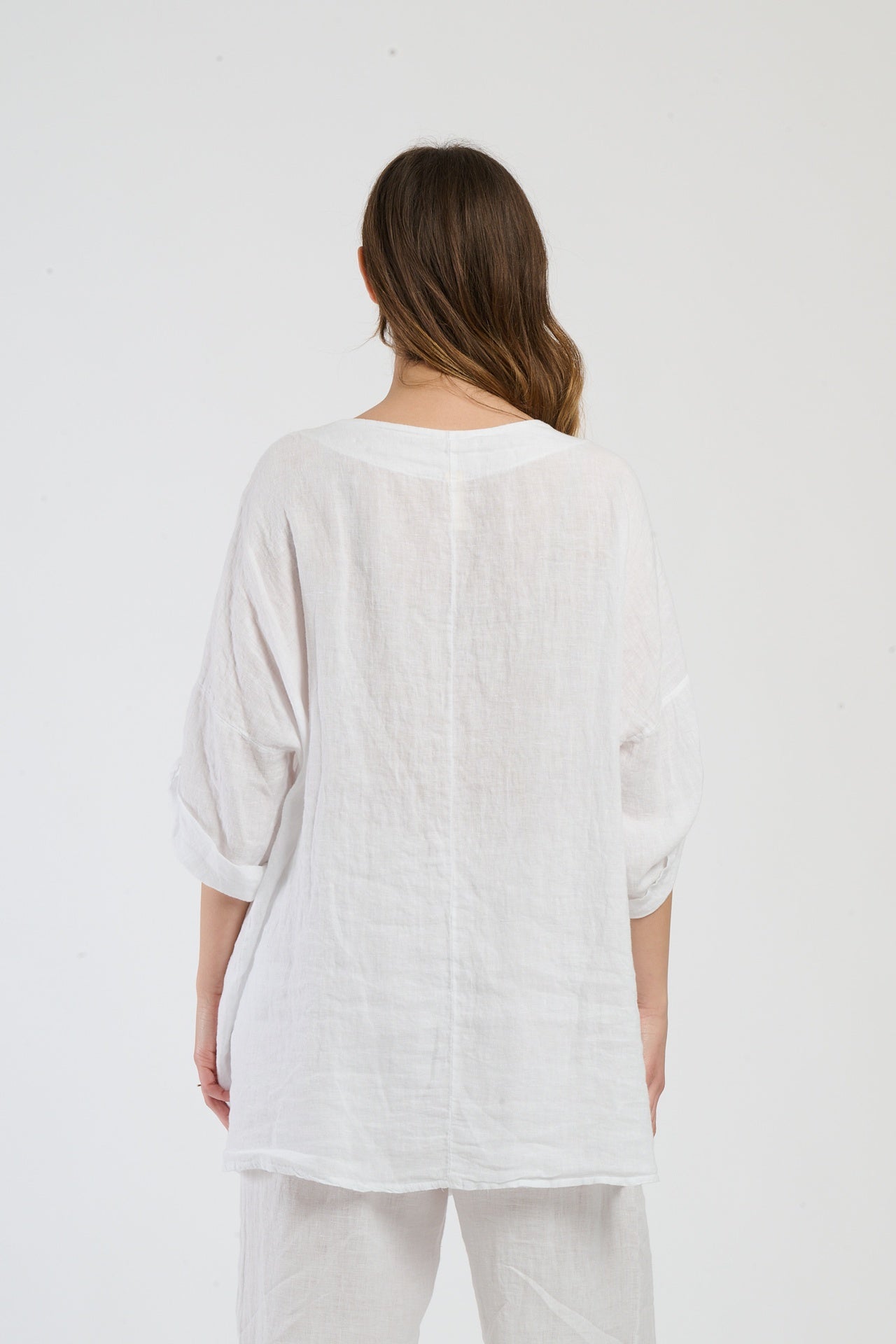 Ensemble bianco, top a maniche corte e pantaloni larghi, serenità per l’estate in città.