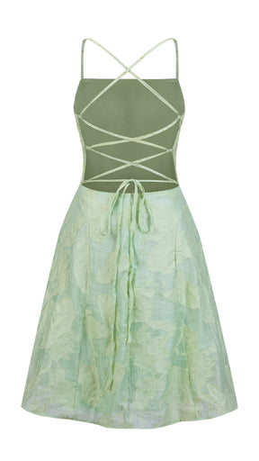 Abito corto elegante a spalline sottili con scollo a fascia, tessuto jacquard floreale e dettaglio a croce sul retro