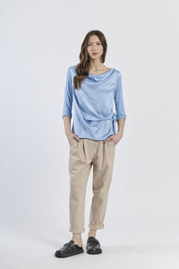 Blusa azzurra conlinea avvolgente e dettagli sartoriali, chic e sofisticata