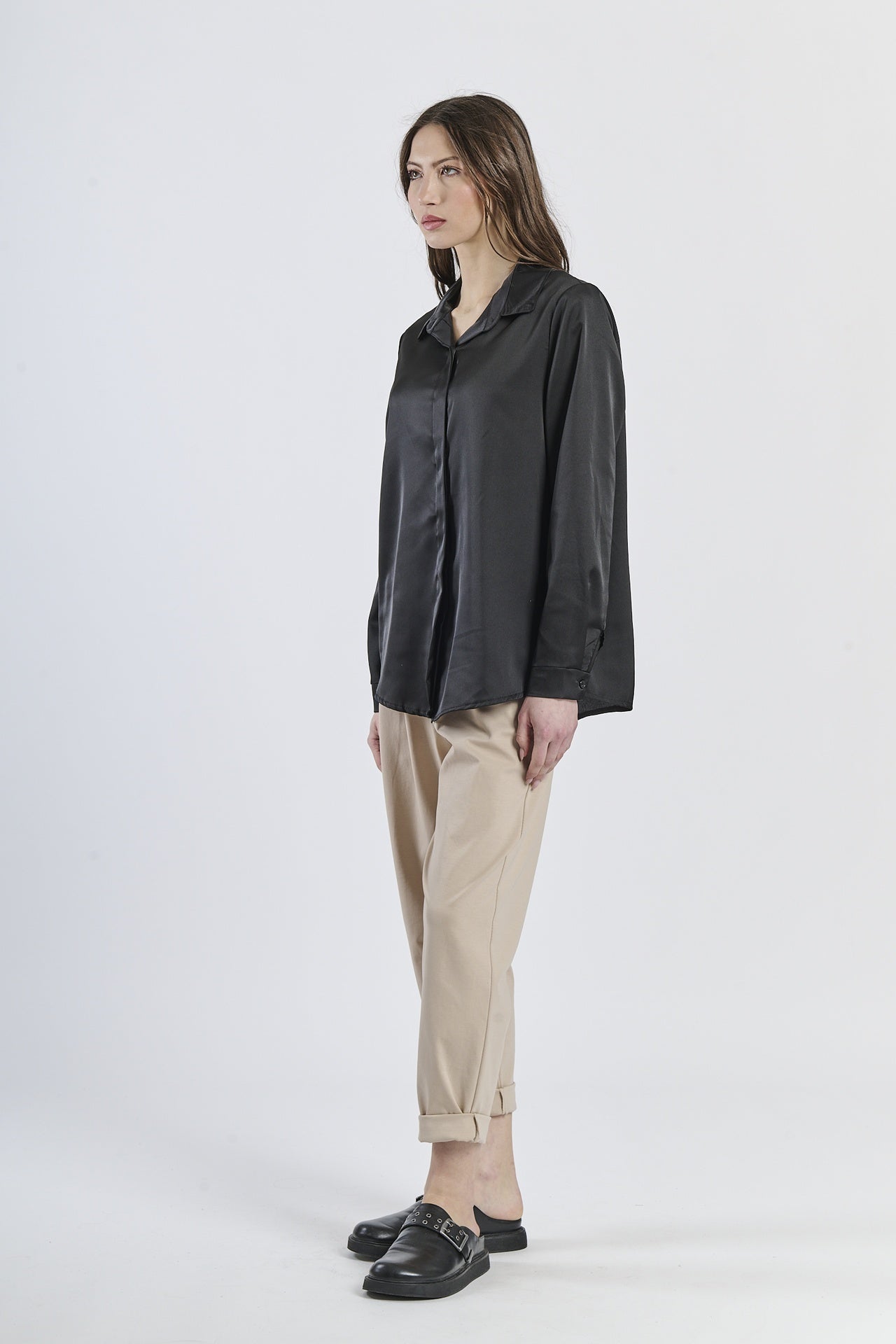 Camicia nera fluida e misteriosa, maniche lunghe e design elegante.