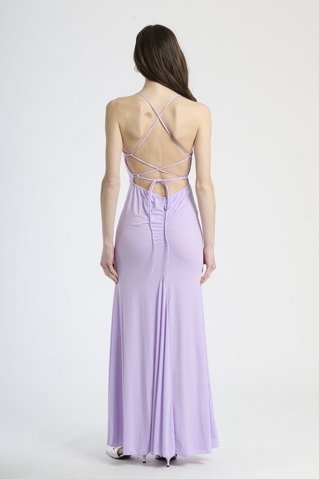 Donna con abito lilla a spalline sottili, mistero romantico ed eleganza magica.