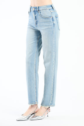 Jeans azzurri con cuciture chiare, abbinati a scarpe argento.