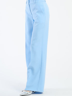 Pantaloni azzurri fluidi con chiusura a bottoni, ideali per l’estate.