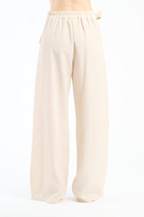 Pantaloni larghi beige con coulisse e nodo, tonalità neutra e versatile.