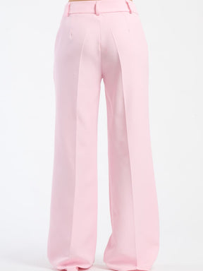 Pantaloni rosa baby fluidi con chiusura a bottoni, vivaci e confortevoli.