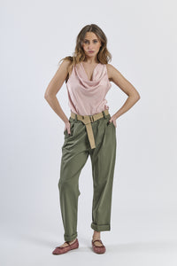 Outfit con top satinato rosa e pantaloni color militare, contrasto stilistico