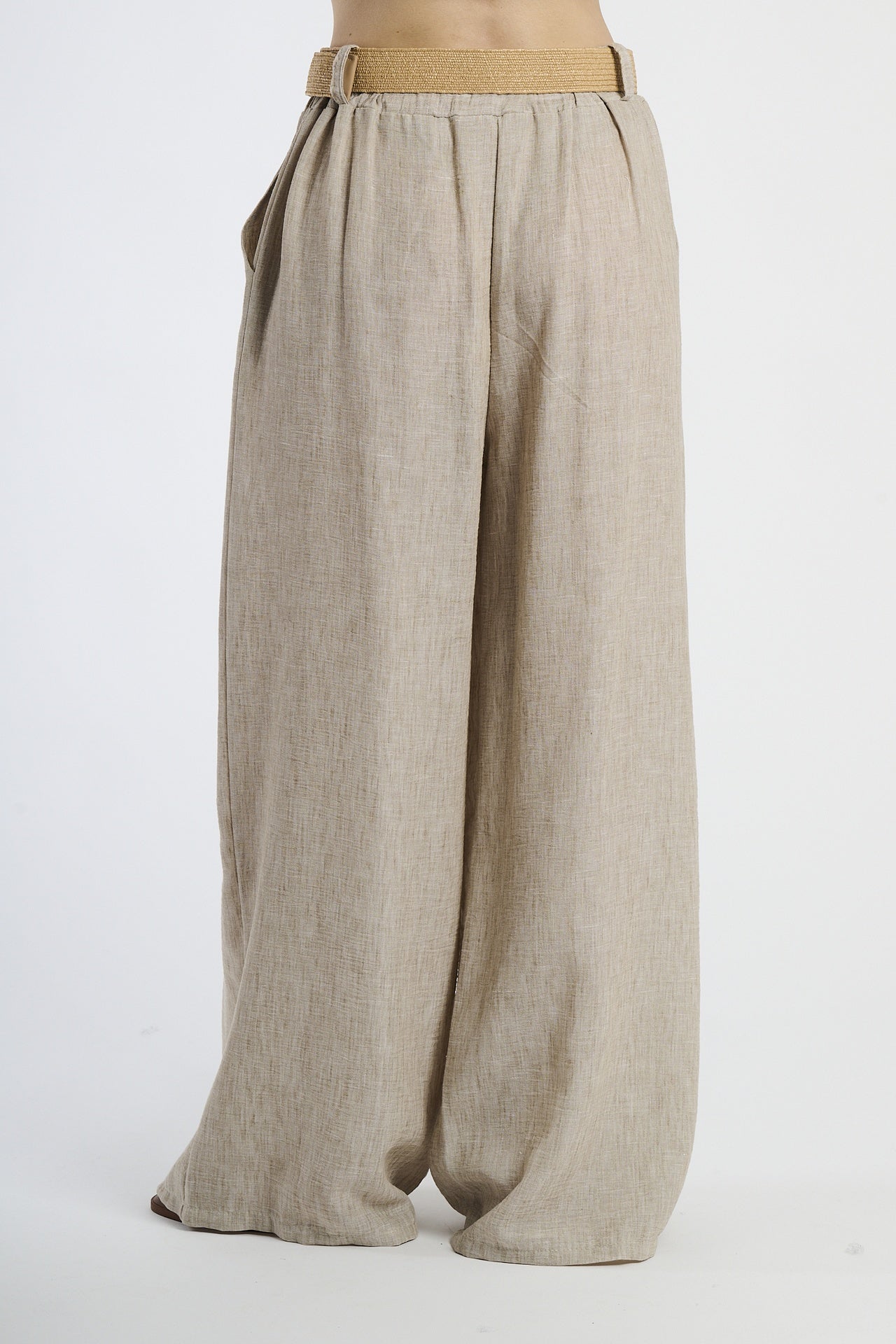 Modella indossa pantaloni tabacco larghi, stile rassicurante ed elegante.