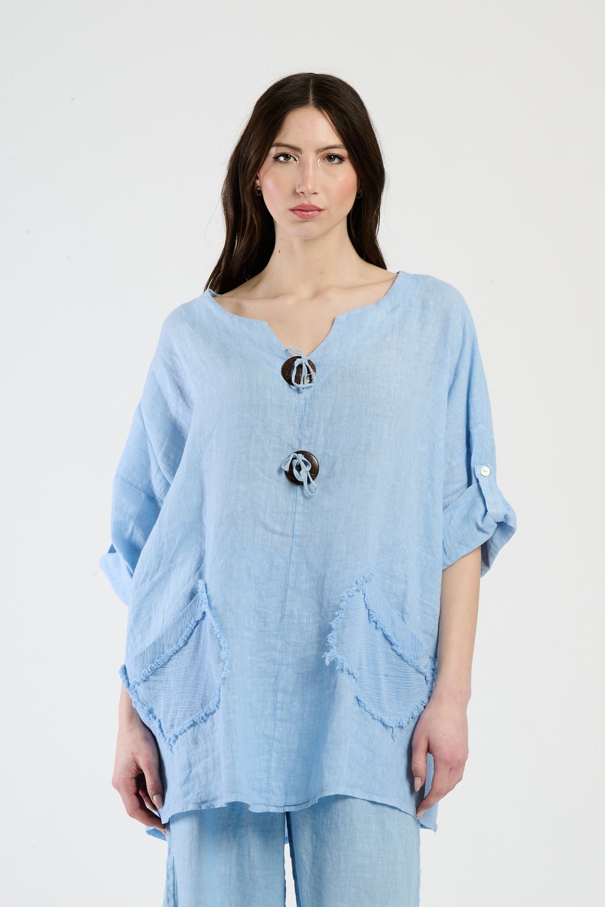 Outfit azzurro in lino, camicetta larga e pantaloni coordinati, stile rilassato per l’estate.