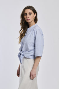 Camicia a righe navy da donna, realizzata in un tessuto leggero con nodo frontale, perfetta per le giornate di primavera.