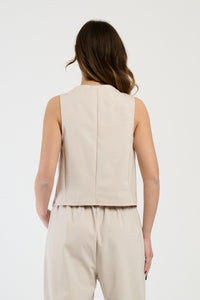 Donna con completo beige: gilet e pantaloni